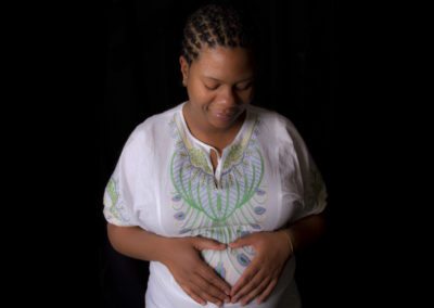 Pregnant black african woman, heart shape with hands