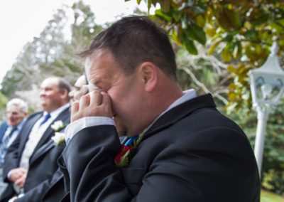 groom crying & wiping his eyes with a tissue, Wallaceville House