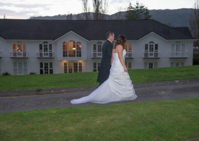 Bride & groom walking along driveway at dusk, Wallaceville House