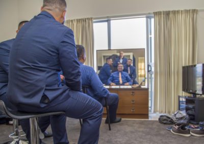 Tokelauan groom and groomsmen joking around at home getting ready for wedding