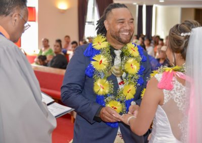 Closeup of colourful Tokelauan bride & groom happily exchanging rings