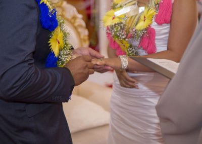 Colourful Tokelauan bride and groom exchanging rings in church