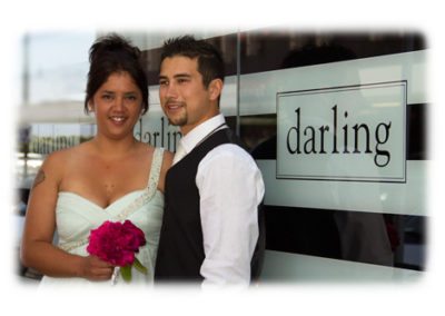 Bride & groom standing beside Darling sign