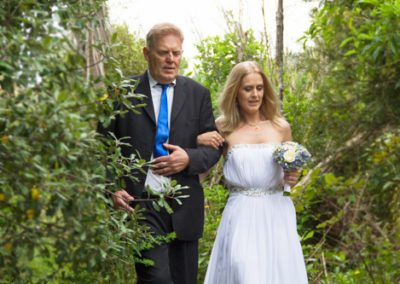 country wedding father walking bride through trees to ceremony