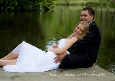 bride & groom laying back at romantic lakeside