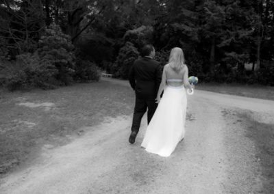 black & white bride & groom walking away hand in hand