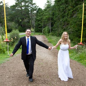laughing bride & groom with flying fox zip line