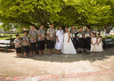Large Samoan bridal party under leafy green tree