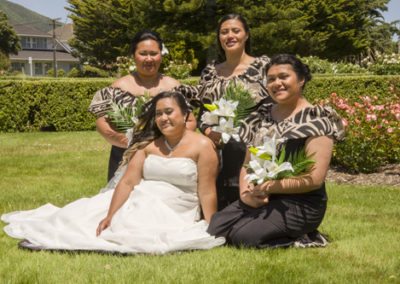 Samoan bride & ladies in sunny windy rose garden