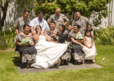 Samoan bridal group joking around on garden seat
