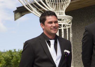 Pencarrow Lodge wedding handsome groom smiling as he first sees bride