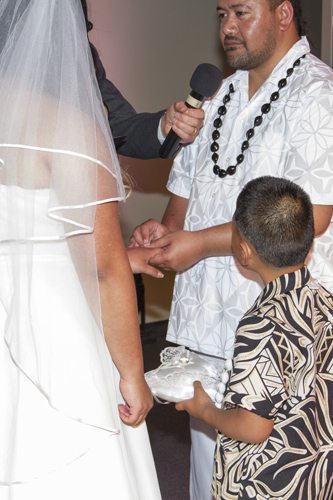 Samoan bride & groom exchanging rings, with ringbearer son watching on