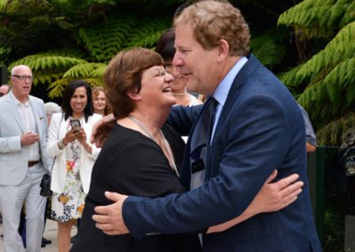 groom hugging older lady at start of wedding