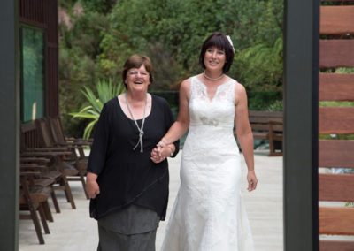 bride arriving holding hands with happy older lady