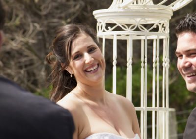 Pencarrow Lodge wedding closeup of bride & groom laughing with celebrant