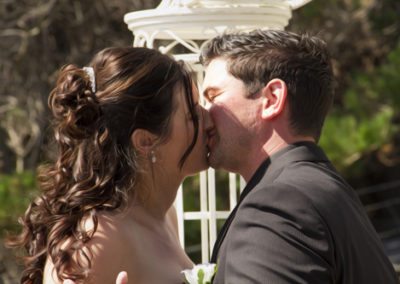 Pencarrow Lodge wedding closeup of bride and groom enjoying first kiss outdoors