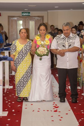 Tokelauan wedding serious looking bride and parents walking her down the aisle