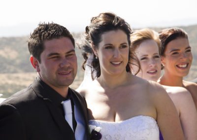 Pencarrow Lodge wedding closeup of windswept bridal party outdoors