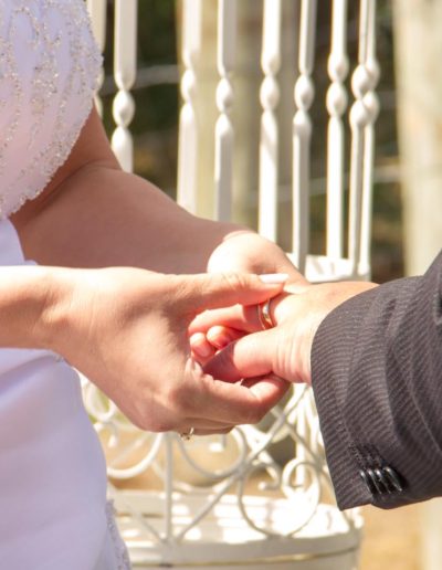 Pencarrow Lodge wedding closeup of bride & groom exchanging rings