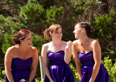 Pencarrow Lodge wedding laughing bridesmaids in purple dresses with trees in background