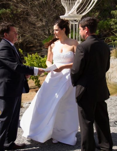 Pencarrow Lodge wedding windswept bride & groom saying vows with celebrant