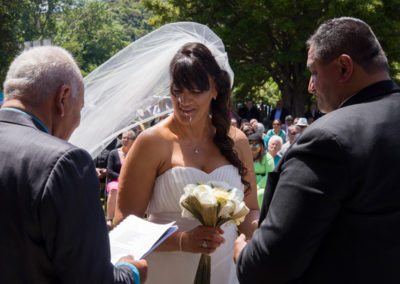 Closeup of Maori bride & groom saying their wedding vows outdoors