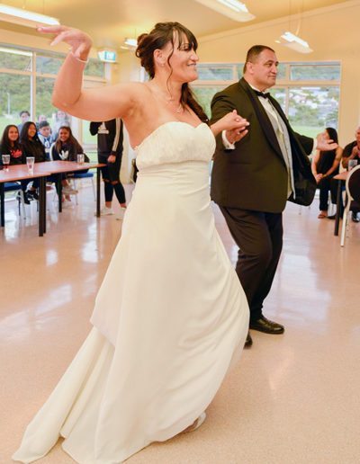 Maori Bride & groom smiling as they perform a dance