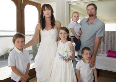 bride & groom & children indoors after wedding ceremony