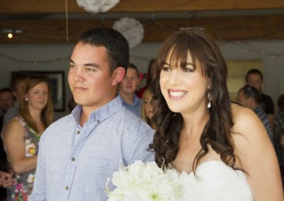 smiling bride walking down aisle with handsome brother