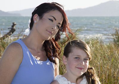 bridesmaid & flower girl in sun at Petone beach