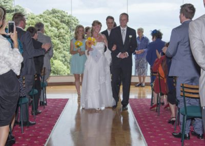 happy bride & groom walking down aisle