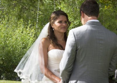 Pensive looking bride closeup in beautiful country setting