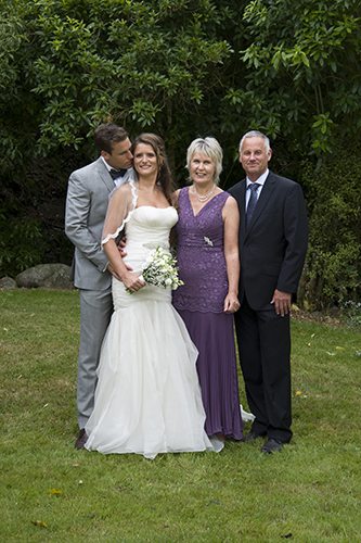 Loving bride & groom with groom's parents