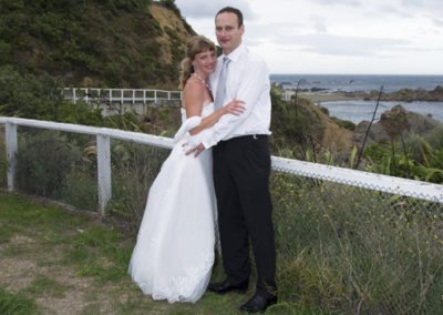 bride & groom hugging outdoors at seaside