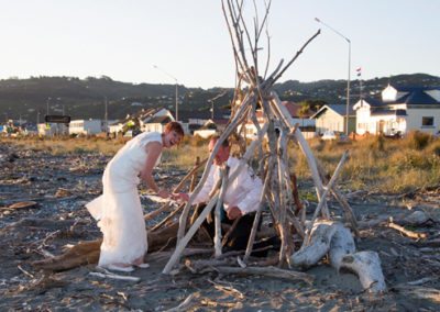 bride & groom in driftwood frame Petone beach