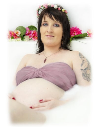 pregnancy maternity pregnant woman in milk bath with pink top and pink flowers