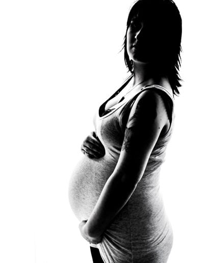 pregnancy maternity black & white image of pregnant woman wearing grey singlet