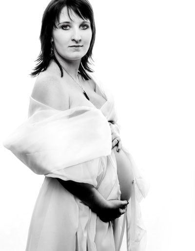 pregnancy maternityblack & white image of pregnant woman with white wrap, exposed belly