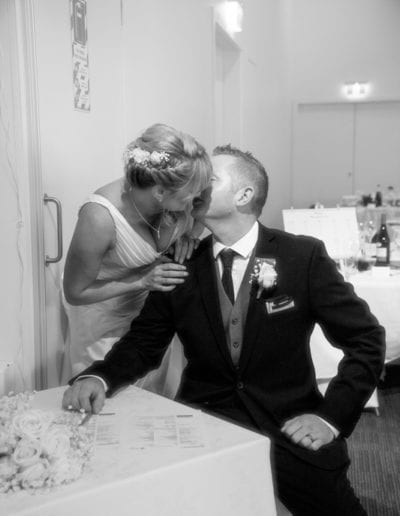 Dowse Art Gallery bride & groom kissing over register