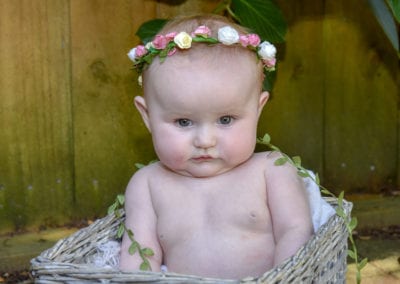 baby girl in cane basket