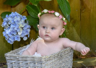 baby girl in cane basket