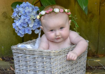 baby girl in cane basket