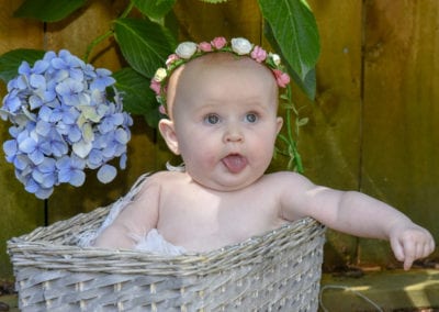 baby girl in cane basket