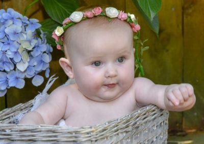 baby girl in cane basket