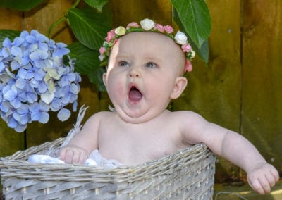 baby girl in cane basket